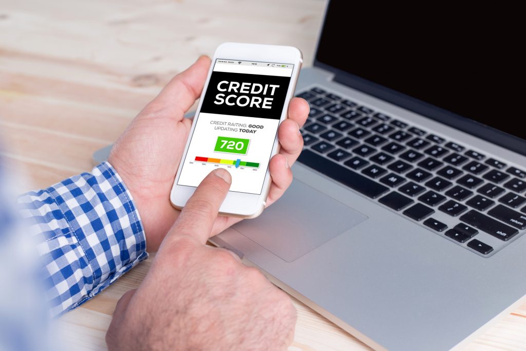 Smartphone in hand and showing Credit Score concept on screen Smartphone in hand and showing Credit Score concept on screen